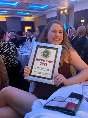 Jodie holding a certificate